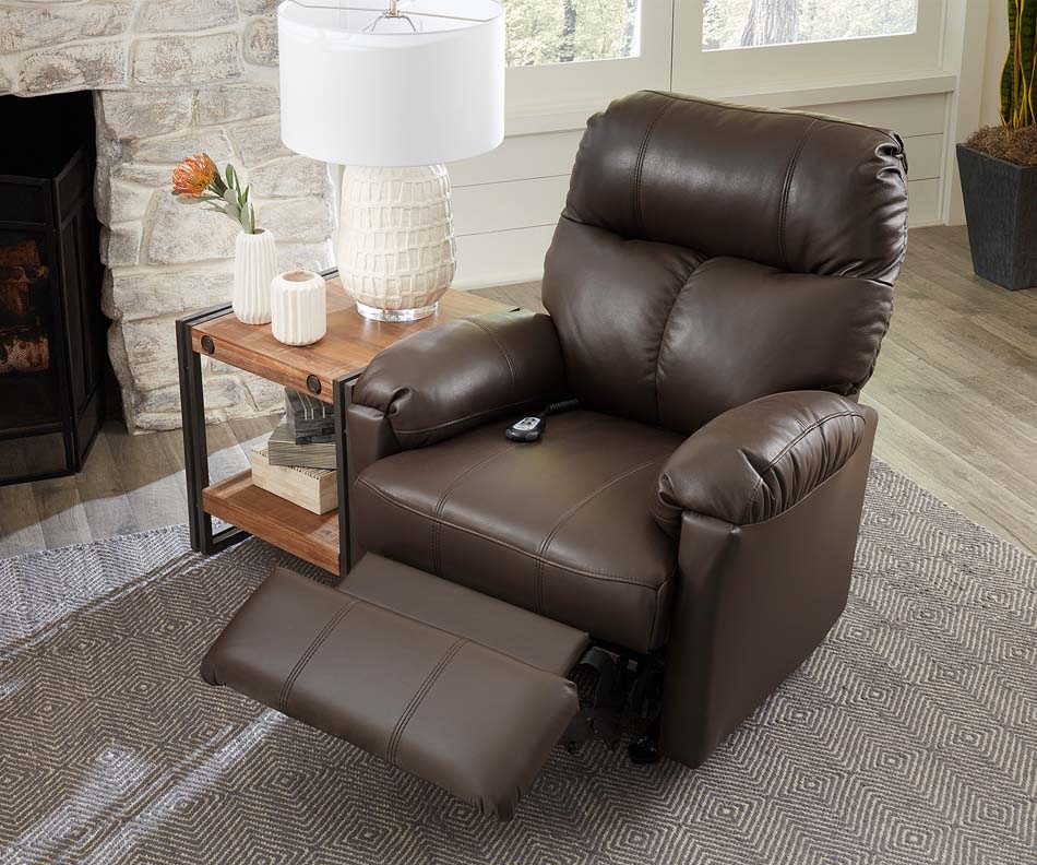 A photo of a dark brown, stuffed leather recliner displays the footrest function
