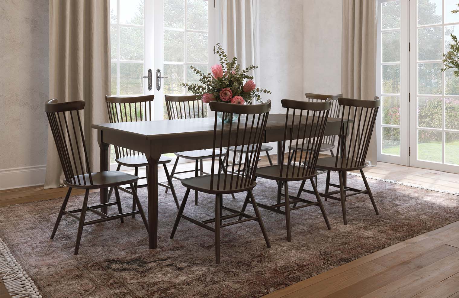 A dark stained wooden dining table with six farm style chairs is exhibited in a naturally lit dining room.
