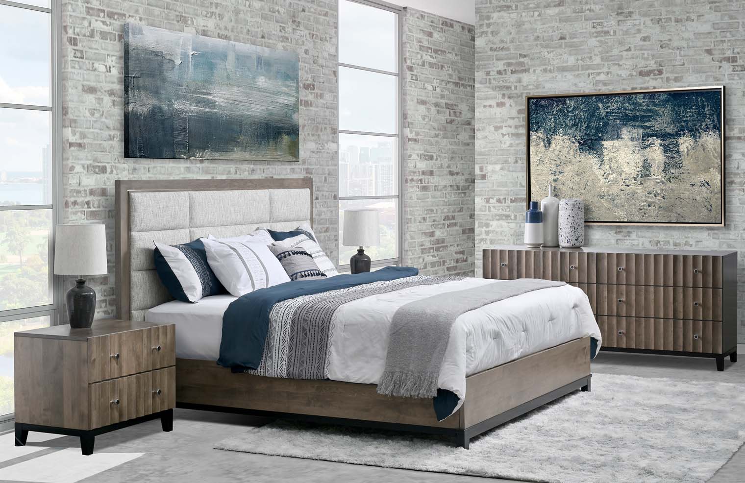 A queen-sized bed sits on a wooden panel bedframe with a quilted upholstered headboard.