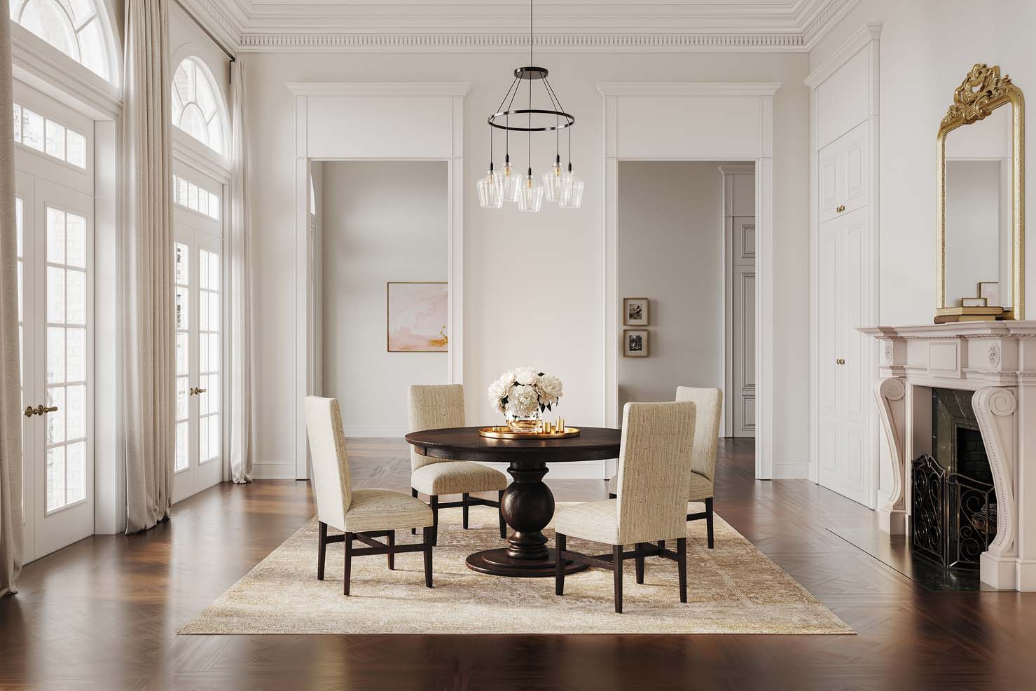 A round dark wooden table with a decorative pedestal leg sits in the middle of a large, vaulted room. Four cream upholstered chairs sit around it.