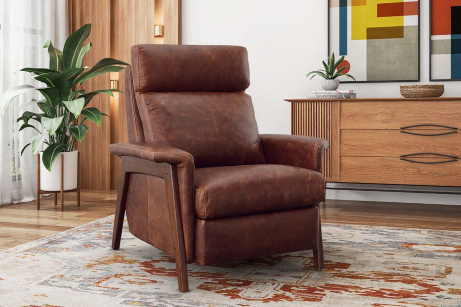 A Mid-Century Modern style chair has plush cushions upholstered in a textured brown leather and a dark wood frame.
