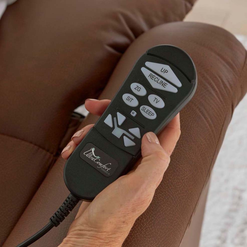 UC559 MED - 2 A person's hand holds the remote used for the power recliners.