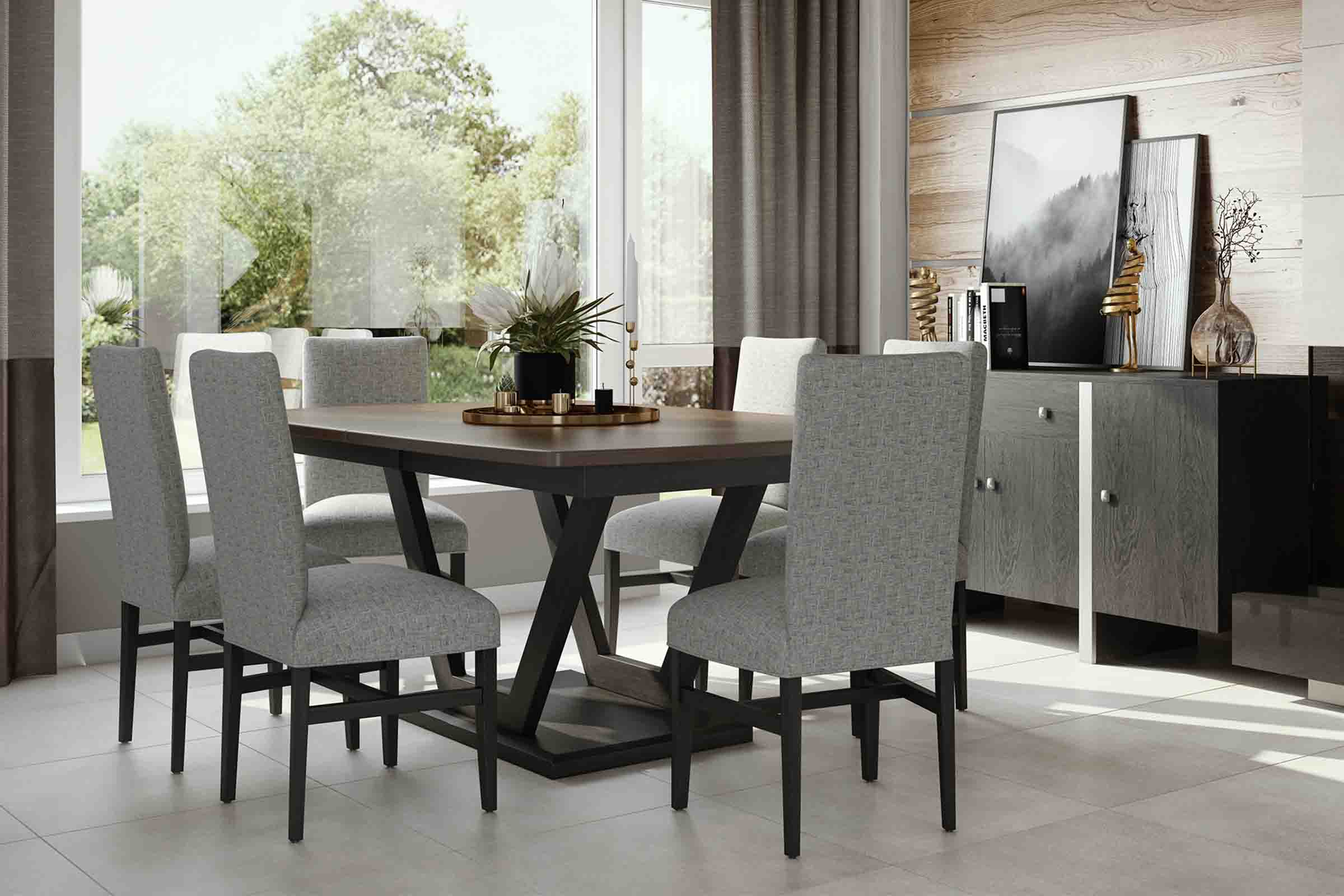 A pedestal table of dark wood is surrounded by 4 tufted sage green chairs.