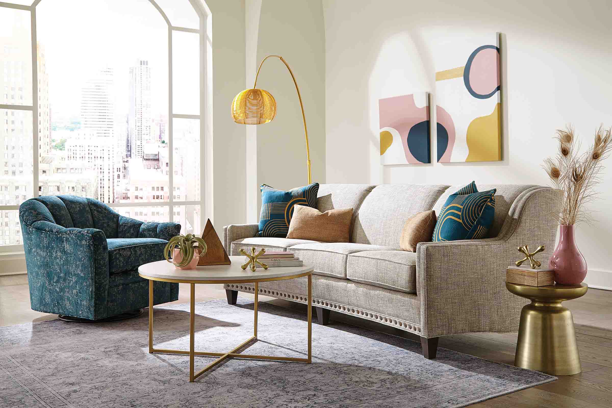 A modernized short sectional with a rounded chaise is upholstered in a textured cream fabric.